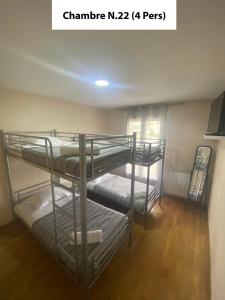 two bunk beds in a room with wood floors at Gîte 4 Le Cerizay - proche du PuyduFou in Cerizay