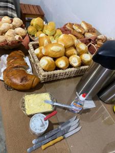a table topped with baskets of bread and pastries at Pousada Vila Artesão in Resende Costa +24 photos
