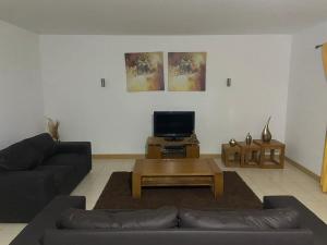 a living room with a couch and a coffee table at Raphis-Belux in Santa Maria