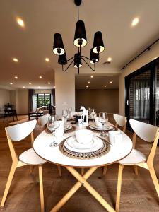 a dining room with a white table and chairs at Entire Luxury Home-Group or Family Traveling Retreat in Wyndham Vale