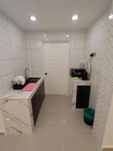 a room with a counter and a white door at Kuromi Homestay Port Dickson Ground Floor in Port Dickson +5 photos