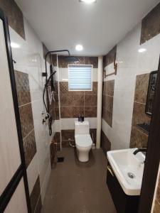 a bathroom with a toilet and a sink at Kuromi Homestay Port Dickson Ground Floor in Port Dickson