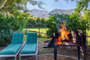 two chairs sitting next to a fire pit at Klein Nektar Wine & Olive Estate in Montagu