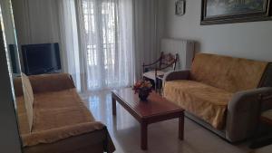 a living room with two chairs and a coffee table at Ευρύχωρο και άνετο διαμέρισμα in Larisa +14 photos