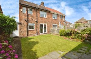 a brick house with a lawn in the yard at Coastal Corporate Stays in Blythe