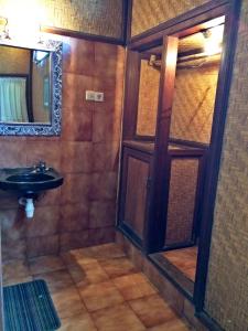 a bathroom with a sink and a mirror at Bella House Monkey Forest in Ubud