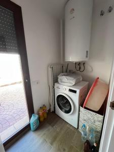 a laundry room with a washer and a washing machine at Villa Buiza in Cunit