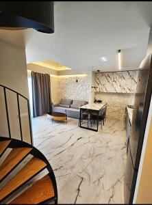 a living room with a couch and a table at Ethereal Residences Nafplio 4 in Nafplio