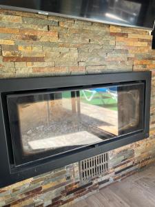 a fireplace with a brick wall with a fire place at Villa Buiza in Cunit