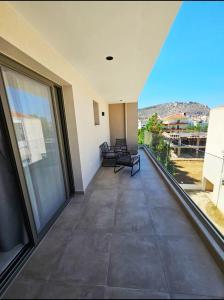 a view from the balcony of a house with large windows at Ethereal Residences Nafplio 4 in Nafplio