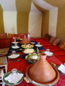 a table with many plates of food on it at Camp atlantic chegaga in Mhamid