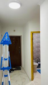 a room with a blue ladder and a toilet at Гарне помешкання in Uzhhorod