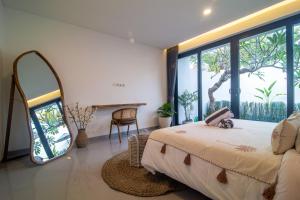 a bedroom with a large bed and a large window at Villa CanSavina - 3 Rooms - Center Of Seminyak in Seminyak +53 photos