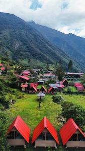 a small village with red roofs on a hill at Salkantay Glamp in Colcapampa