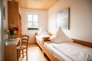 a room with two beds and a desk and a table at Fh "luv" in Ueckermünde