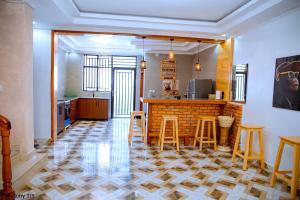 a kitchen with a counter and stools in a room at maman home apartment in Gisenyi