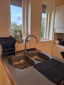 a kitchen counter with a sink and a window at The Sunflower - Huge 240m2 7-bedroom house for 16 people - Free parking - 15 beds, 2 kitchen & 3 bathrooms in Munkebo +51 photos