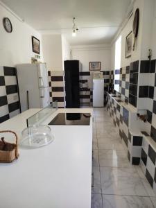 a kitchen with black and white tiles on the wall at Château de Clairefontaine du XVIIIème siècle à Garchizy in Garchizy