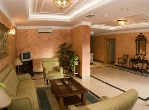 a living room with couches and a table in a room at Hotel los Girasoles in Valencina de la Concepción