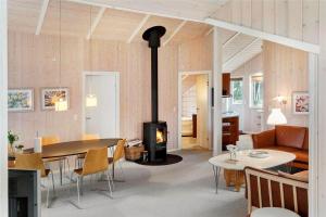 a living room with a wood stove in a room at M12018-Vaeggerlose-Baeverstien-11 in Marielyst