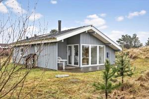 a small grey house with a porch and a deck at TV1567-Bindslev-Svingelvej-9 in Tversted