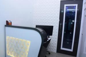 a mirror in a room with a desk and a chair at O C E A N Dormitory T-2 in Mumbai +18 photos