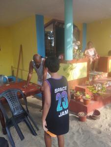 a man standing next to a man in a room at Ever green home stay in Alleppey