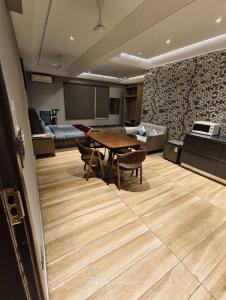 a room with a table and chairs and a couch at KRYC Luxury Living near Indraprastha Apollo Hospital in New Delhi