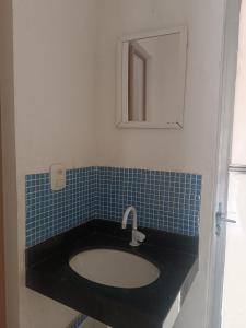 a bathroom with a sink and a mirror at loft barbudo in Araruama