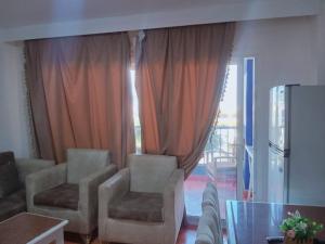 a living room with chairs and a glass table at 321or322 the finest Porto Marina Chalets Tower 3 in El Alamein