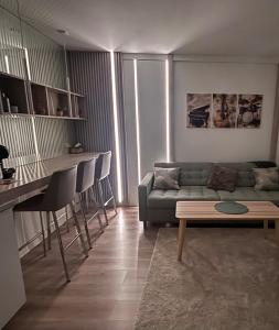 a living room with a couch and a table at Modern Apartment in City Center in Iaşi