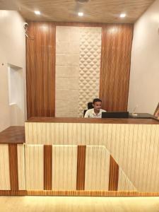 a man sitting at a desk in an office at JP International Naimisharanya in Naimishāranya