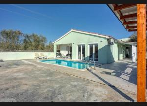 a house with a swimming pool in front of it at Vila Didi in Fažana