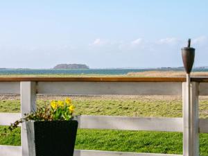 a view of the ocean from a fence at Secluded Retreat by Water - By Traum Ferienwohnungen in Bøjden +24 photos