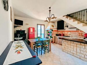 a kitchen with a table and chairs in a room at Polizzihouse in Polizzi Generosa