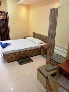 a bedroom with a bed and a desk and a chair at ARITHANG TASHI near M G marg in Gangtok