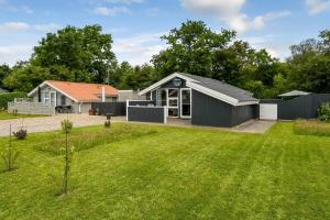 a home with a large yard with a house at C11722-Hemmet-Bork-Hytteby-39 in Falen
