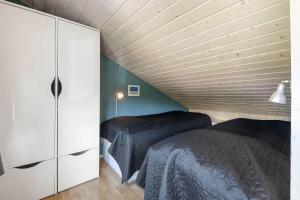 a bedroom with two beds and a wooden ceiling at C11729-Hemmet-Vester-Faelled-192-I1 in Falen +18 photos