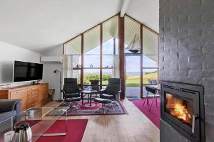 a living room with a fireplace and a tv at SB125-Egernsund-Marinavej-28 in Rendbjerg