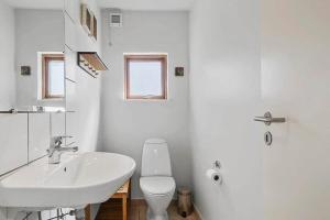 a white bathroom with a sink and a toilet at SB125-Egernsund-Marinavej-28 in Rendbjerg +12 photos
