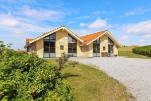 a house with a gravel driveway in front of it at SB125-Egernsund-Marinavej-28 in Rendbjerg