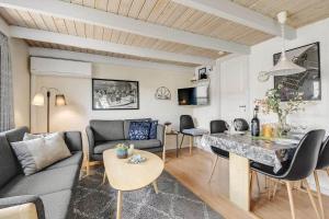 a living room with a couch and a table at C11726-Hemmet-Vester-Faelled-120-E1 in Falen