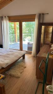a bedroom with a large bed and a large window at Chalet Hakuna Matata Ovronnaz in Ovronnaz