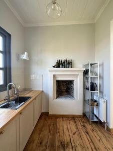 a kitchen with a fireplace in the middle of a room at Entire House & Garden - Chokhelis' Telavi Retreat in Tʼelavi