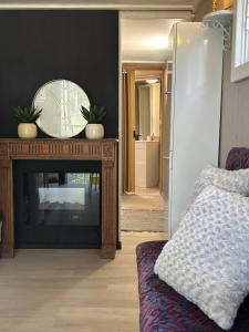 a living room with a television and a mirror at De Middendijk in Damme