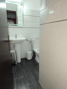 a white bathroom with a sink and a toilet at Villa Frideriki in Agia Paraskevi +67 photos