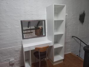 a white desk with a mirror and a chair at Barrymicasa Self Catering in Gqeberha
