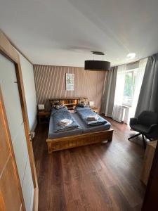 a bedroom with a bed and a chair in it at Hutorok in Strübbel