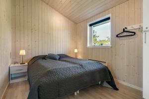 a bedroom with a bed and a window at C11353-Tarm-Ronnebaervej-1 in Højsand