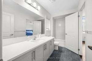 a white bathroom with a sink and a toilet at Cozy 5 bedrooms & 5 bathrooms House in Tottenham +17 photos